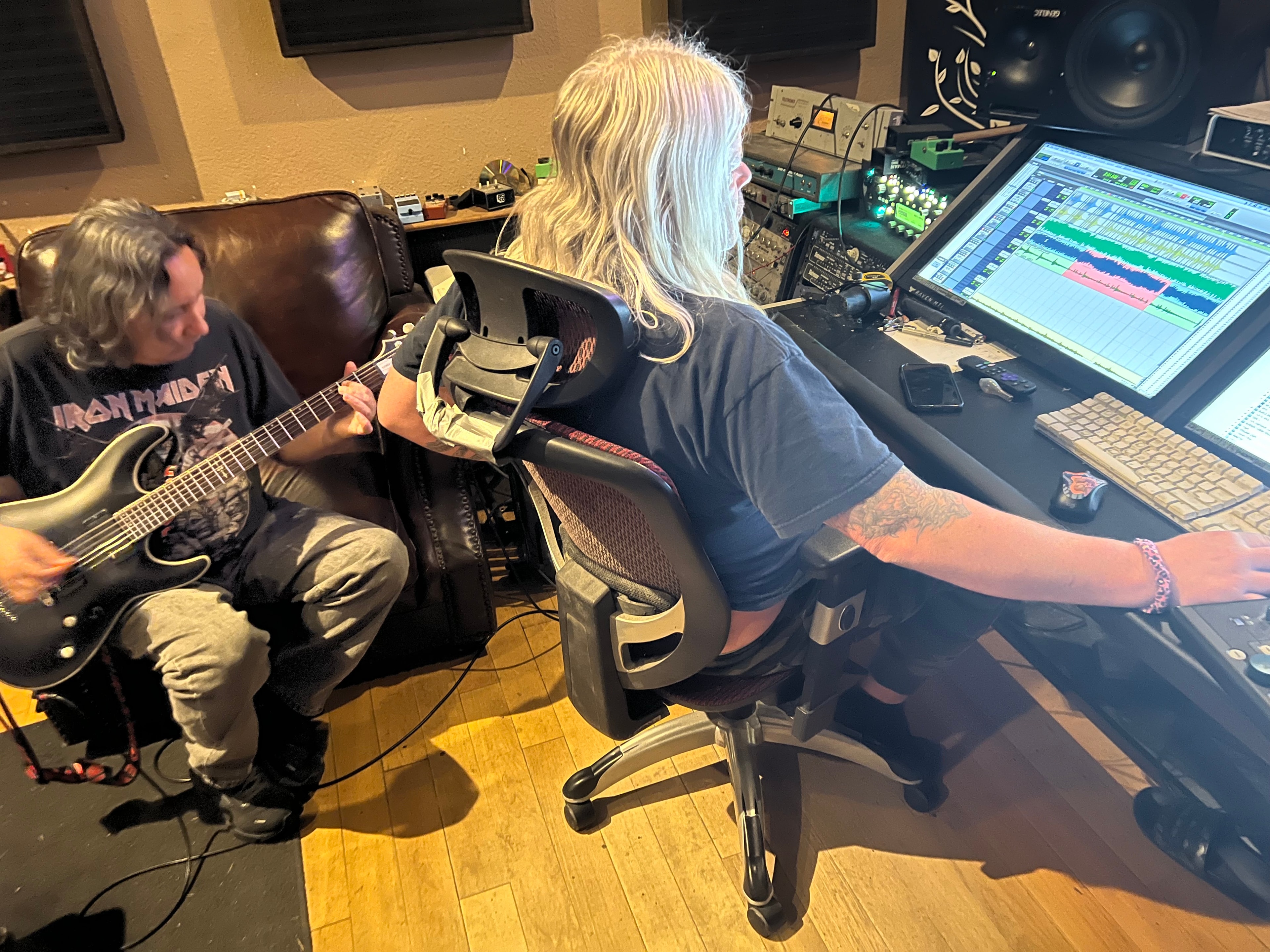 Ace laying down guitar tracks with producer Juan Urteaga in the studio, 2023